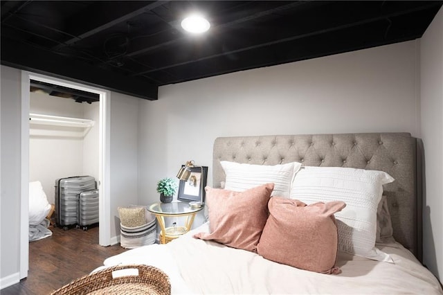 bedroom with a closet and dark hardwood / wood-style floors