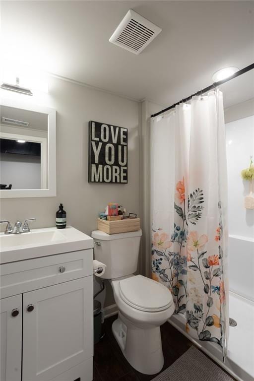 bathroom featuring vanity, toilet, and a shower with shower curtain