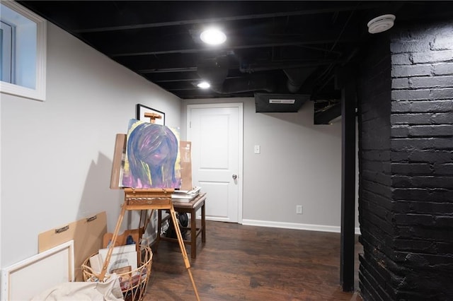 basement featuring dark hardwood / wood-style flooring