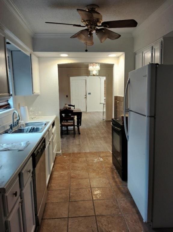 kitchen featuring ceiling fan with notable chandelier, light tile patterned floors, white refrigerator, dishwasher, and white cabinetry