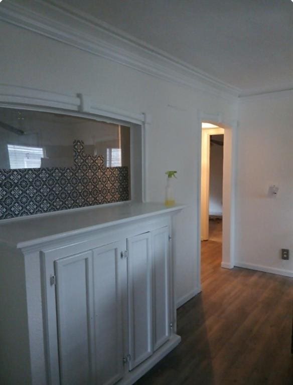 hall featuring dark hardwood / wood-style floors and crown molding