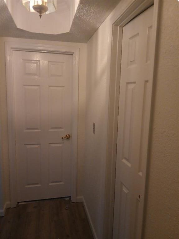 entryway with dark hardwood / wood-style flooring and a textured ceiling