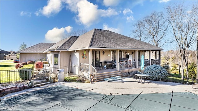 back of house featuring a covered pool and a patio