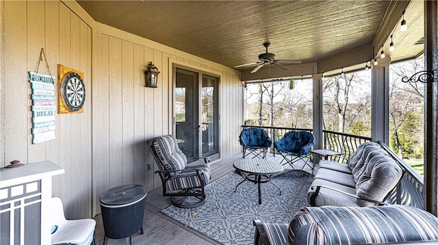 sunroom with wood ceiling and ceiling fan