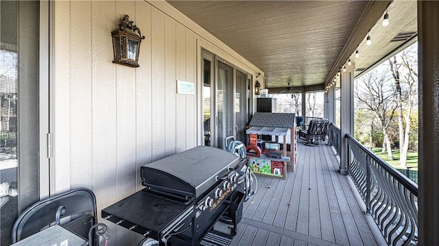 wooden deck with a grill