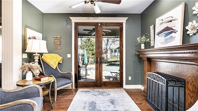 entryway featuring dark wood-type flooring, ceiling fan, and french doors