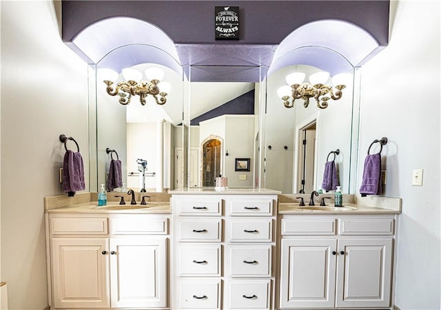 bathroom featuring lofted ceiling and vanity