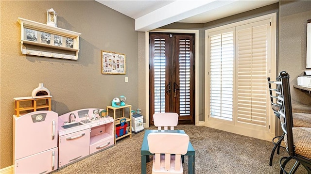 game room featuring french doors and carpet flooring