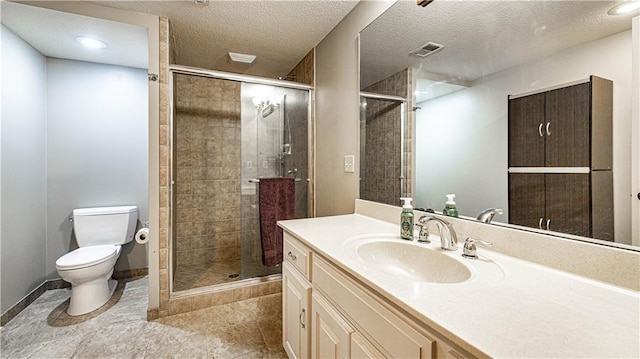 bathroom featuring vanity, toilet, an enclosed shower, and a textured ceiling