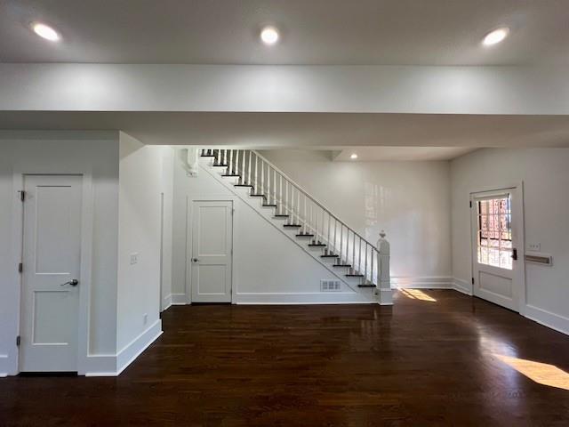 entryway with dark wood-type flooring