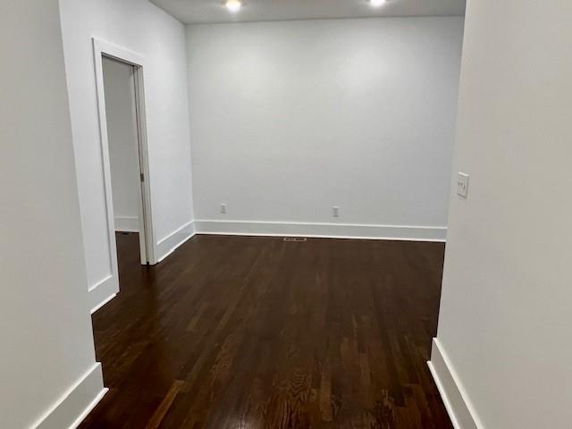 spare room featuring dark hardwood / wood-style flooring