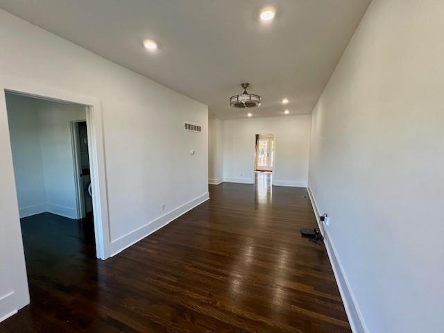 spare room featuring dark hardwood / wood-style flooring