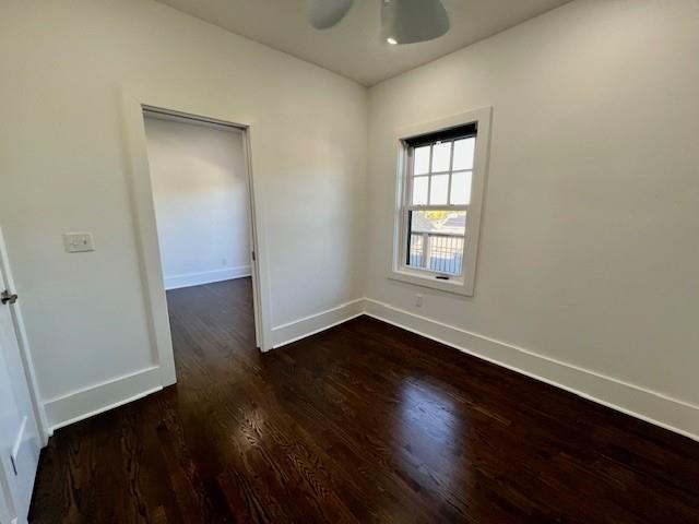 spare room featuring dark hardwood / wood-style floors and ceiling fan