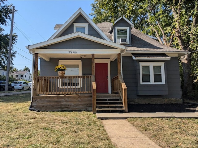 view of front of home featuring a front yard and covered porch