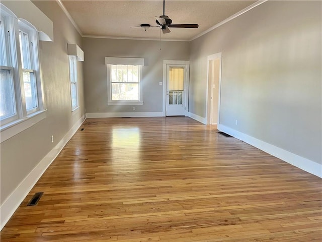 unfurnished room with light hardwood / wood-style flooring, a textured ceiling, ceiling fan, and crown molding