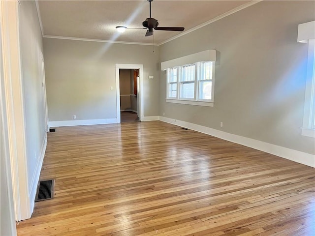 unfurnished room featuring light hardwood / wood-style flooring, crown molding, and ceiling fan