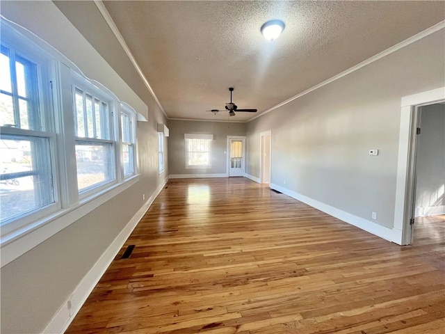 unfurnished room with ornamental molding, hardwood / wood-style floors, a textured ceiling, and ceiling fan