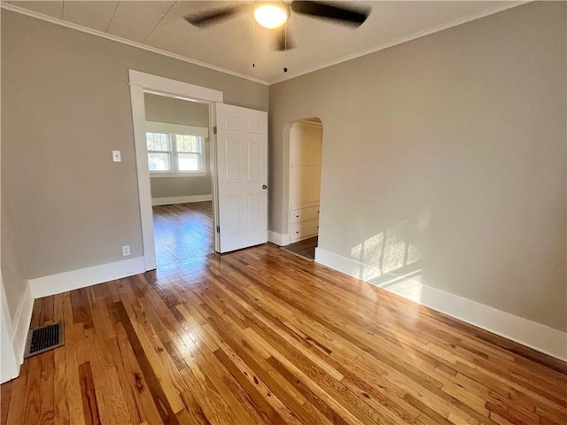 spare room with ceiling fan, hardwood / wood-style flooring, and ornamental molding