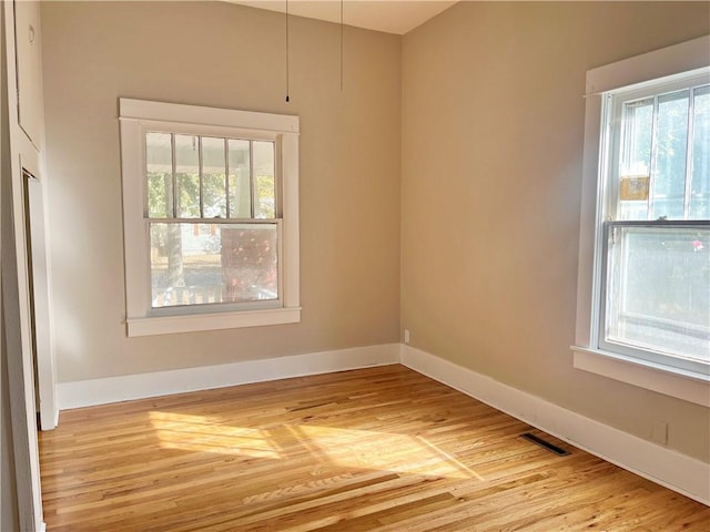 spare room with light hardwood / wood-style flooring