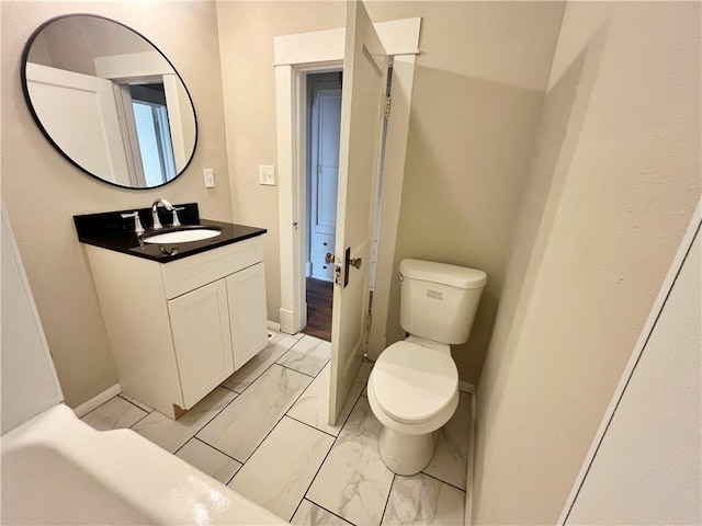 bathroom featuring vanity and toilet