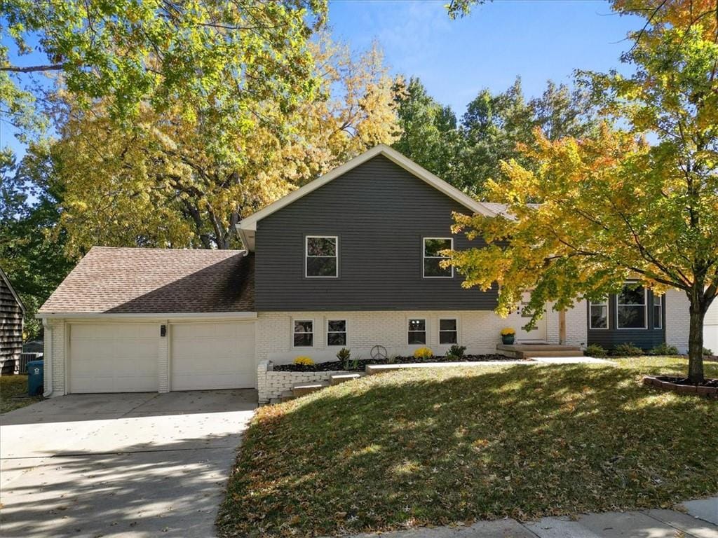 view of front of house with a front yard and a garage