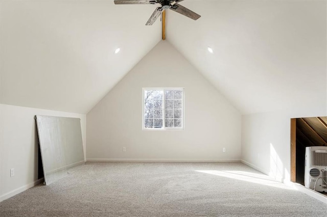 additional living space with carpet flooring, ceiling fan, baseboards, and lofted ceiling