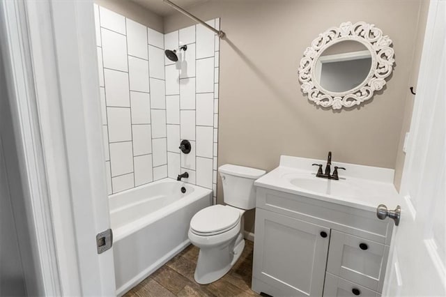 bathroom featuring toilet, vanity, bathtub / shower combination, and wood finished floors