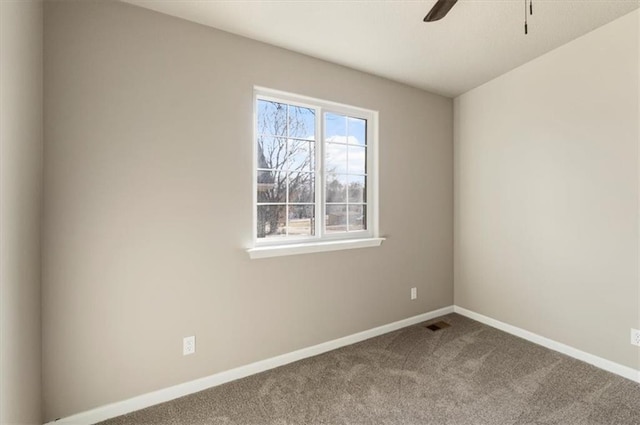 empty room with ceiling fan, baseboards, and carpet