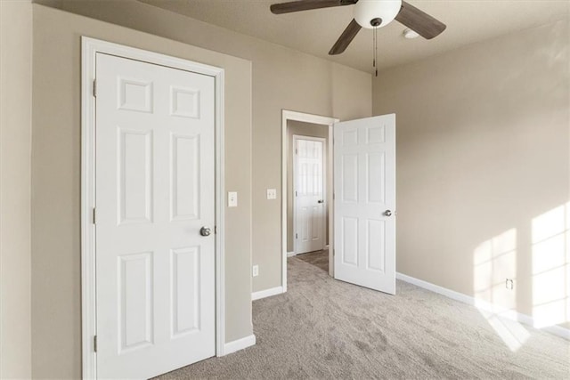 unfurnished bedroom with carpet flooring, a ceiling fan, and baseboards