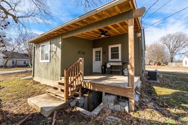 back of property with central AC unit and a ceiling fan