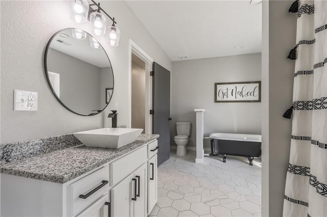 bathroom with tile patterned floors, vanity, and toilet