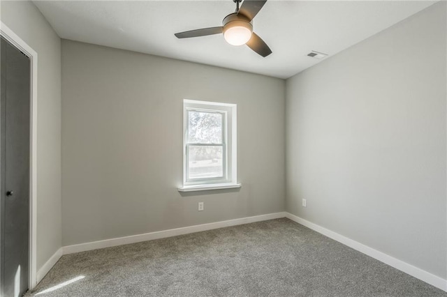 carpeted spare room featuring ceiling fan