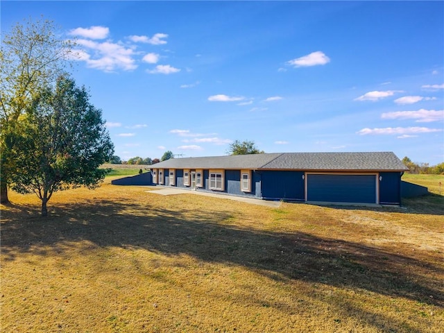 single story home featuring a front lawn and a garage