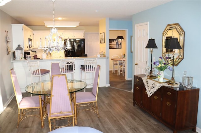 dining space with a chandelier and dark hardwood / wood-style floors