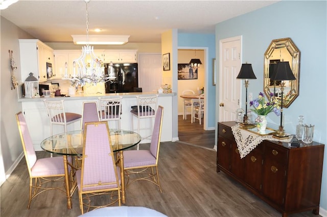 5850 Park Cir, Shawnee, KS 66216 - dining room featuring dark wood finished floors, a chandelier, and baseboards