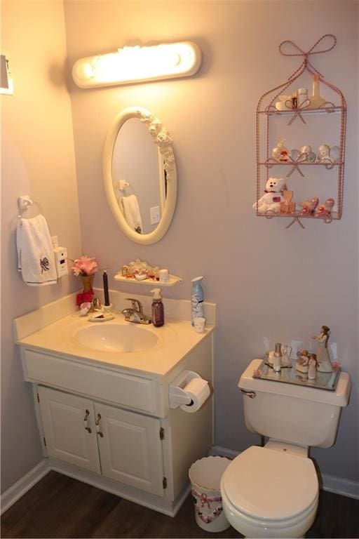 bathroom featuring vanity, hardwood / wood-style floors, and toilet