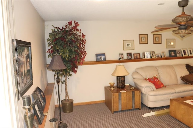 carpeted living room with ceiling fan