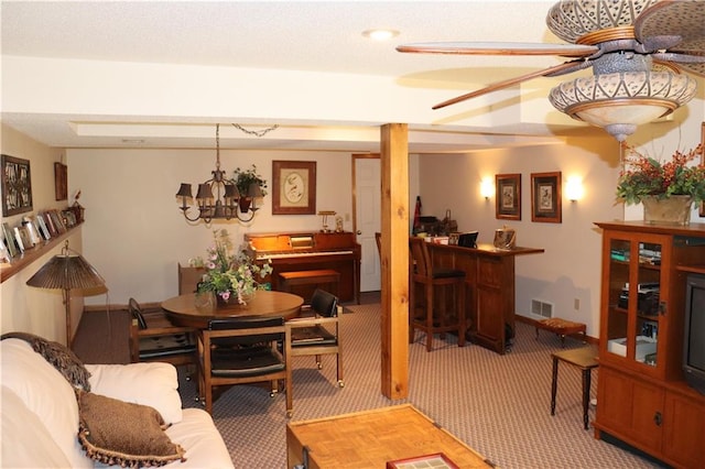 carpeted living room featuring a notable chandelier