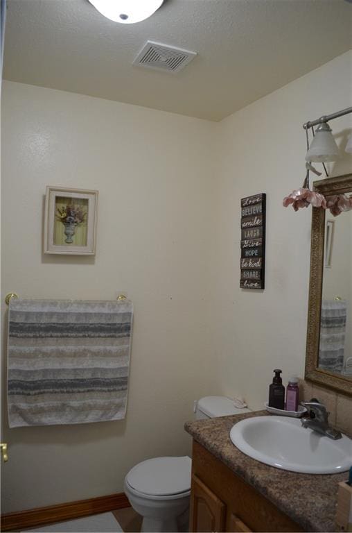 bathroom with toilet and vanity