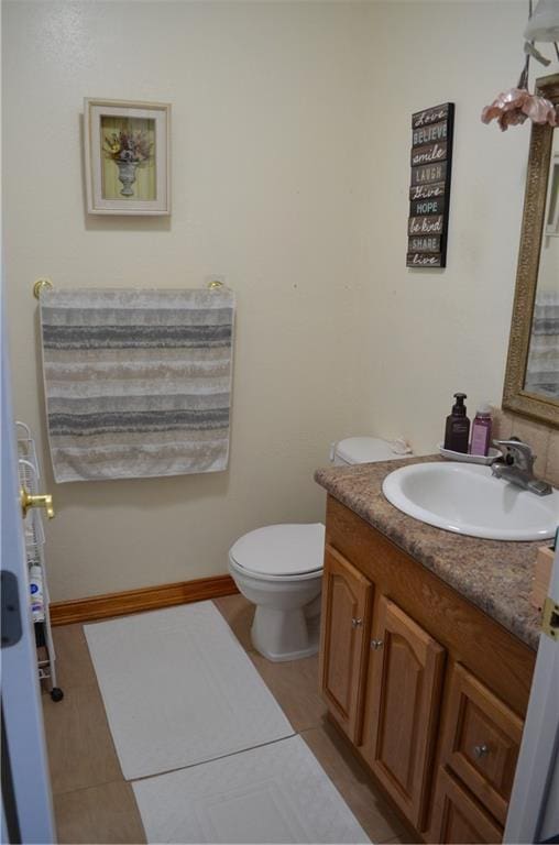 bathroom with vanity, toilet, and tile patterned flooring