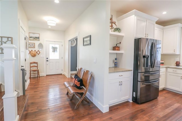 kitchen featuring dark hardwood / wood-style flooring, white cabinets, and stainless steel fridge with ice dispenser