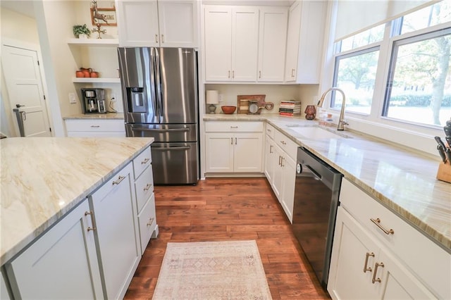 kitchen with dark wood-type flooring, appliances with stainless steel finishes, sink, and white cabinets