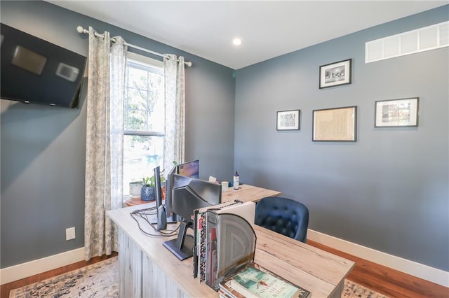 home office with wood-type flooring