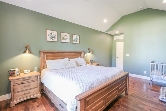 bedroom featuring lofted ceiling and dark hardwood / wood-style floors