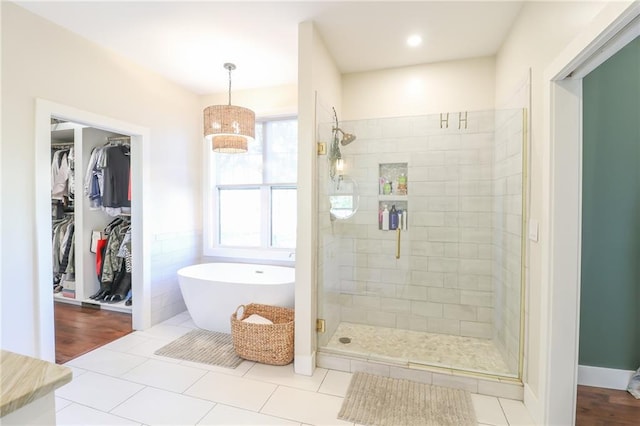 bathroom featuring tile patterned floors and plus walk in shower