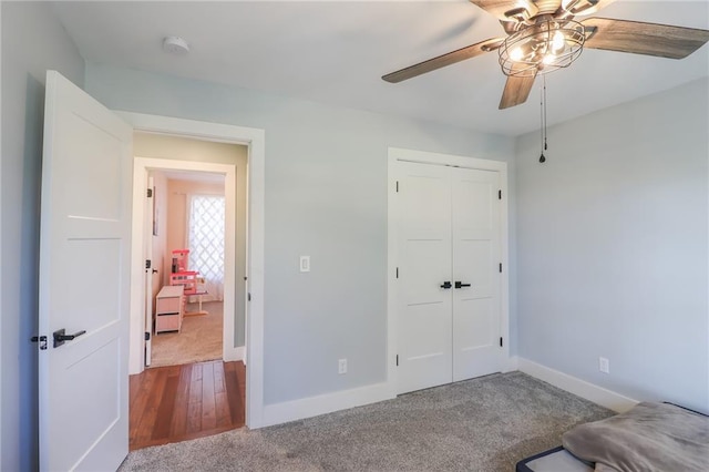 unfurnished bedroom with a closet, ceiling fan, and wood-type flooring