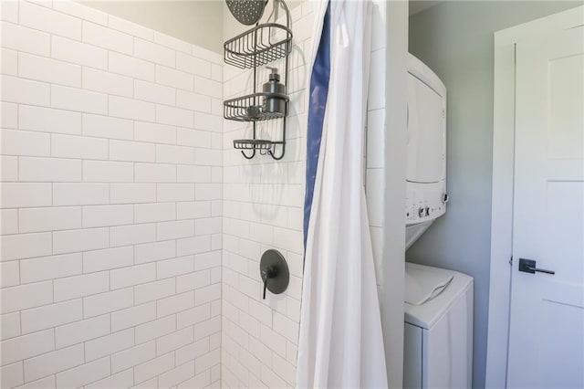 bathroom featuring walk in shower and stacked washer and dryer