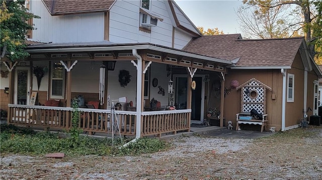 rear view of property with covered porch