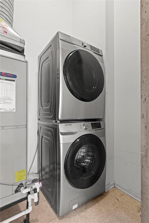 laundry room with stacked washer / drying machine