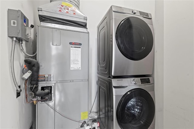 clothes washing area with stacked washer and clothes dryer